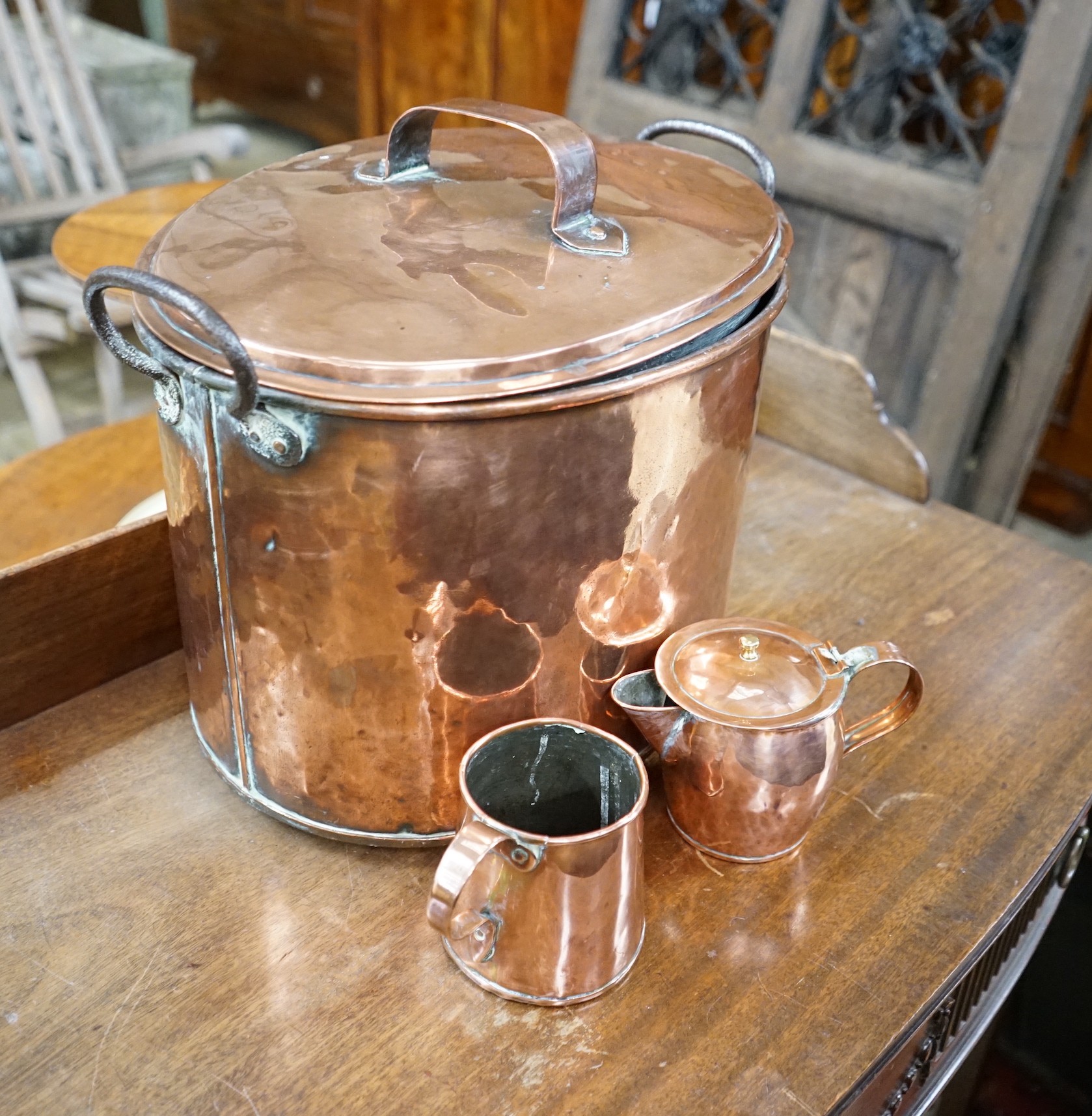 A Victorian oval copper lidded cauldron, height 33cm together with a Victorian copper measure and a jug